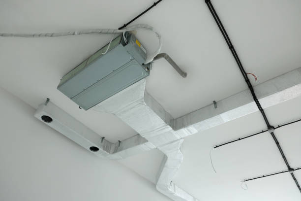 Team installing a ducted cooling system inside a property under fit-out