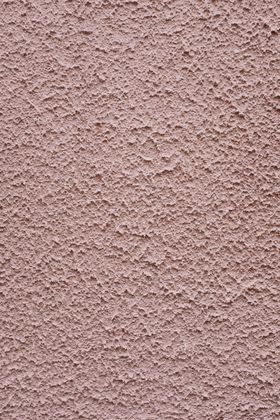 Worker applying a textured finish to a wall