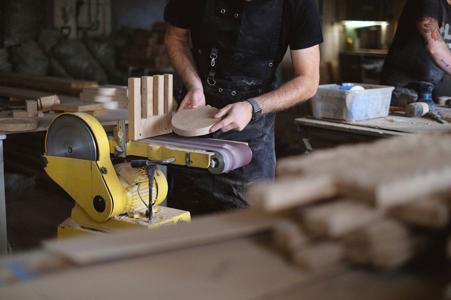 An MQ craftsman finishing woodwork by hand