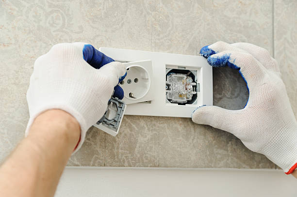 Electrician preparing cable ends for a new socket