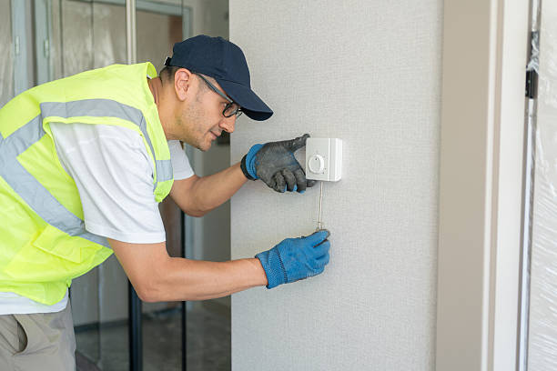 Technician repairing an AC control board with precision tools